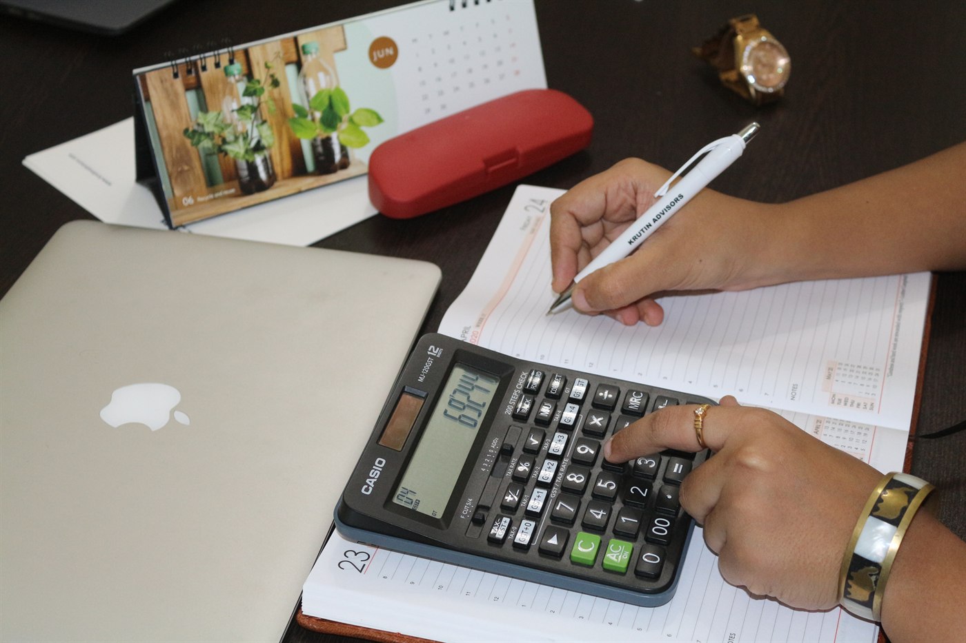 Finance desk with calculator and working papers